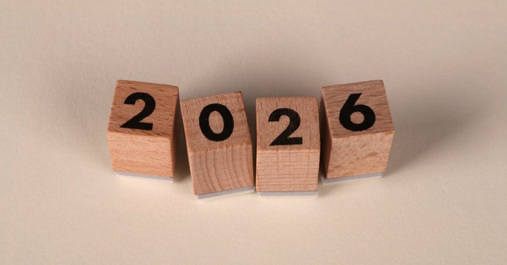 Wooden cubes forming the year 2026 on a neutral background.
